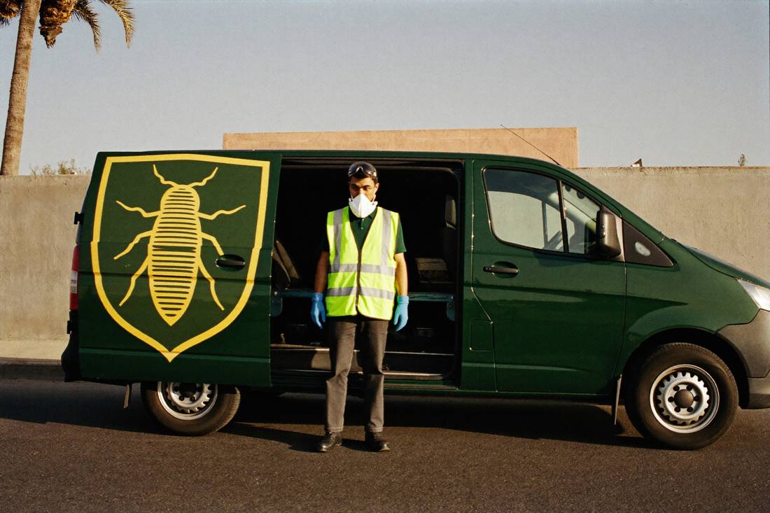 PUMP pest control technician in front of the company van in Riyadh